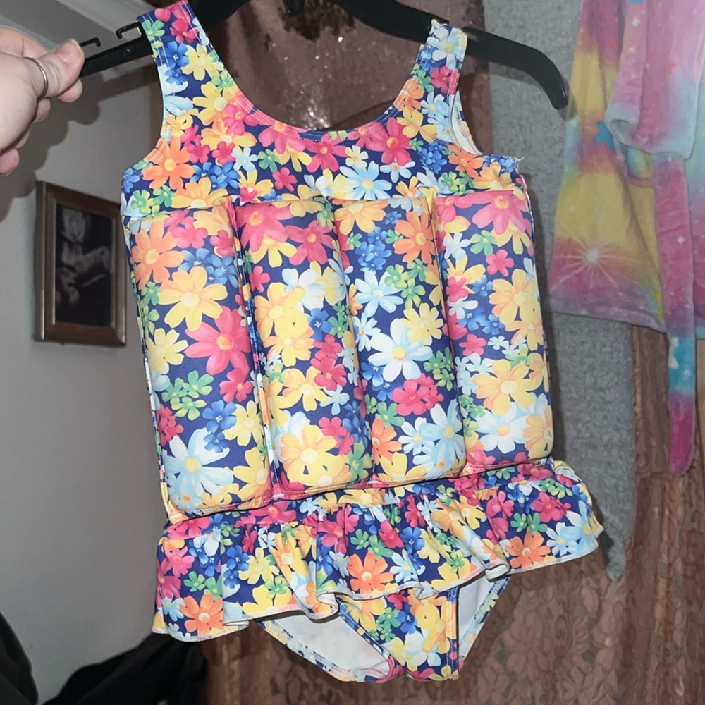 Swim suit with floaty tubes inside the suit.